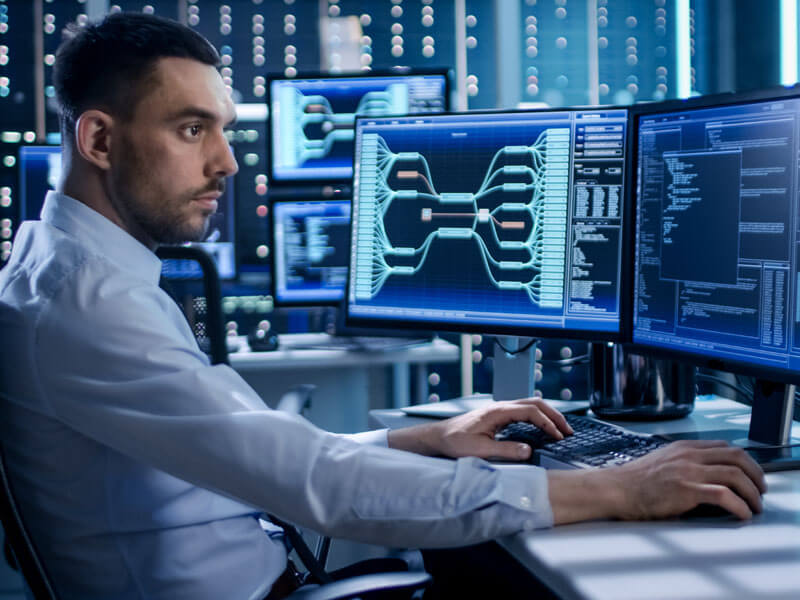 man monitoring global compliance security on monitors