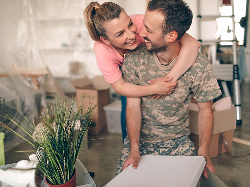 married couple packing for military move