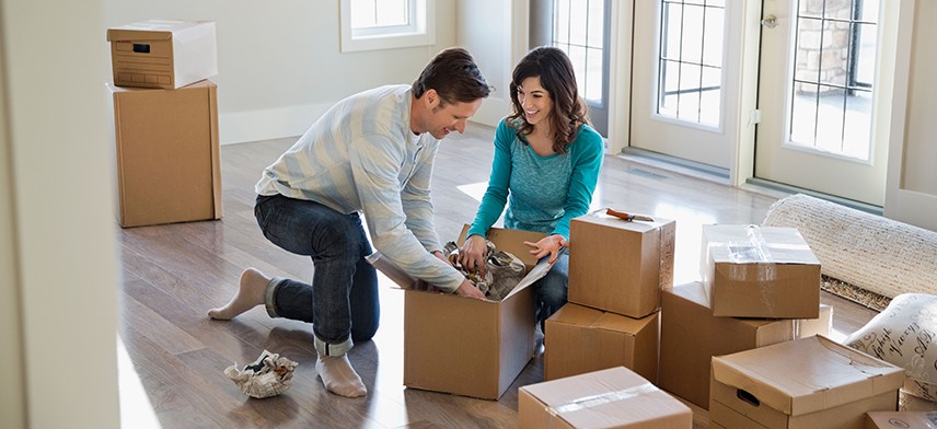couple packing boxes for home move