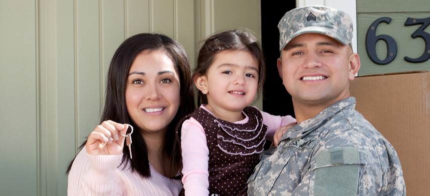 military family holding key to new home after moving
