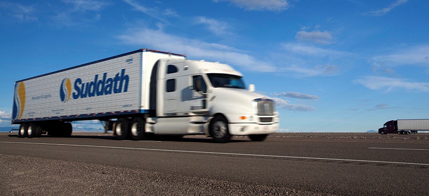 suddath long distance moving truck driving on highway