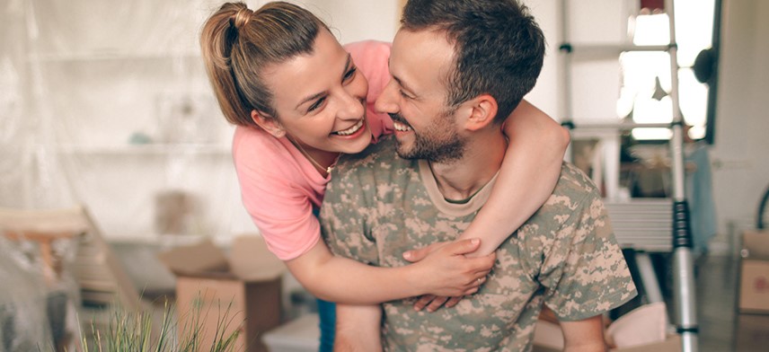 young couple packing for military move