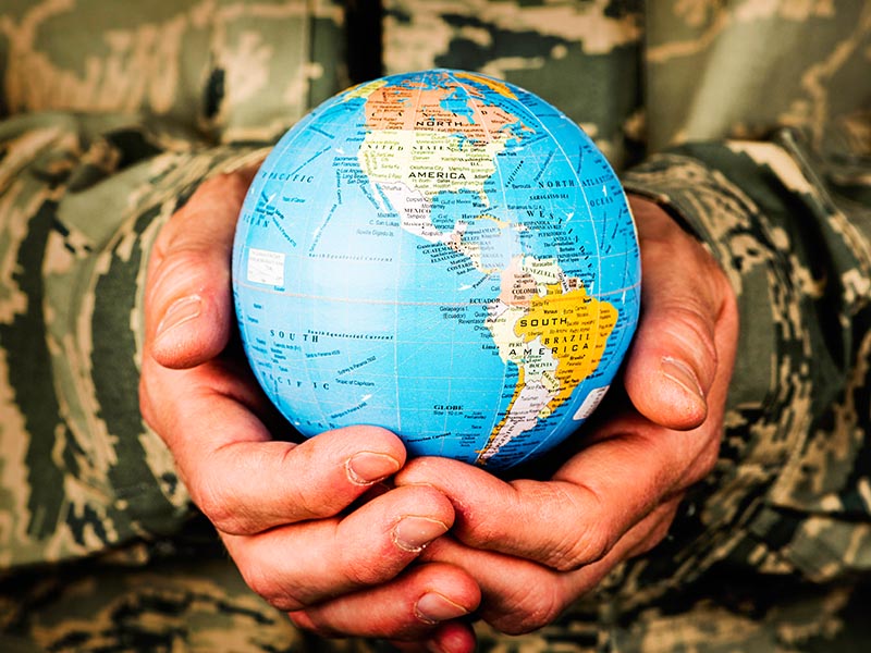 american soldier holding globe