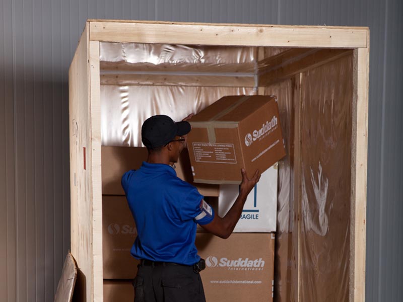 mover putting moving box into container