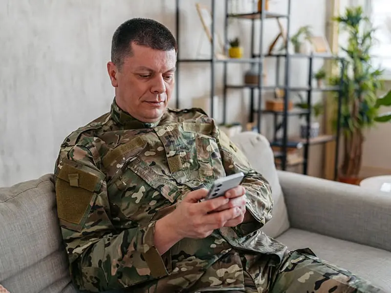 Suddath military member tracking shipment on smartphone at home