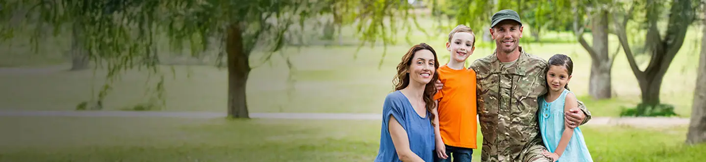 Suddath military family of five smiling together outdoors in park setting