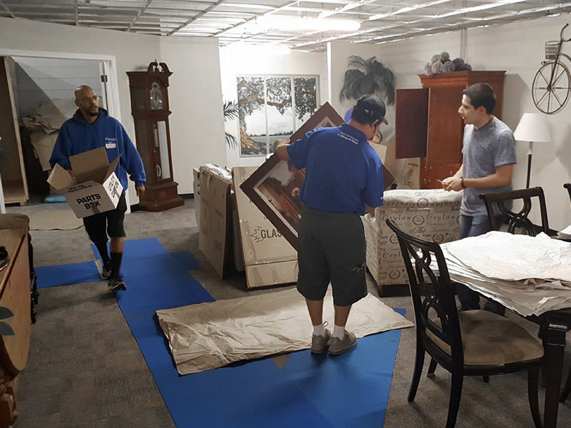 movers packing home items at suddath university