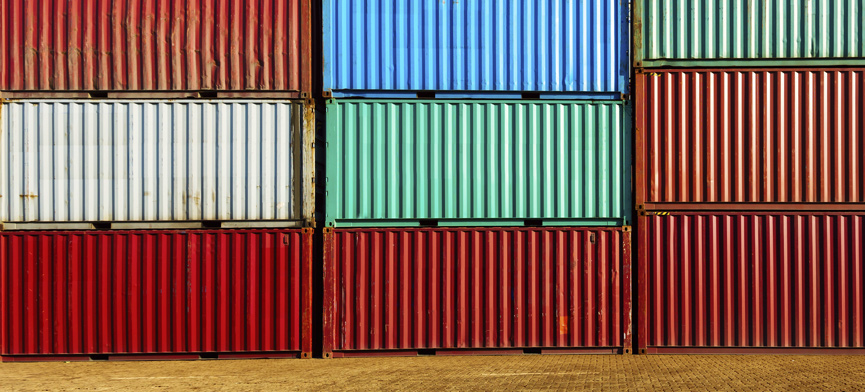 stacked shipping containers in port yard