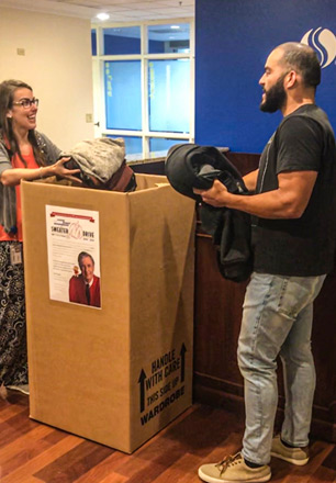 employees collecting clothing at 2019 sweater drive